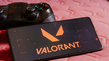 In this photo illustration, the Valorant logo is displayed...