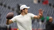Jan 11, 2025; Houston, Texas, USA; Los Angeles Chargers quarterback Justin Herbert (10) warms up before playing against the Houston Texans in an AFC wild card game at NRG Stadium. Mandatory Credit: Thomas Shea-Imagn Images