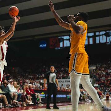 Dec 22, 2024; Tuscaloosa, Alabama, USA; Alabama Crimson Tide guard Houston Mallette (95) shoots from the three point line against Kent State Golden Flashes center Cli'Ron Hornbeak (42) during the second half at Coleman Coliseum. Mandatory Credit: Will McLelland-Imagn Images