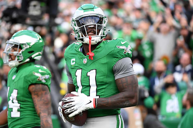 Eagles WR A.J. Brown throws the football into the stands after scoring a touchdown .