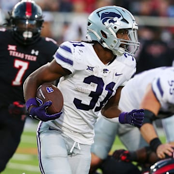 Oct 14, 2023; Lubbock, Texas, USA;  Kansas State Wildcats running back Dj Giddens (31) rushes against the Texas Tech Red Raiders in the first half at Jones AT&T Stadium and Cody Campbell Field. Mandatory Credit: Michael C. Johnson-Imagn Images