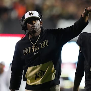 Colorado Buffaloes quarterback Shedeur Sanders (2) and head coach Deion Sanders following a two point conversion in the fourth quarter against the Colorado State Rams at Folsom Field.