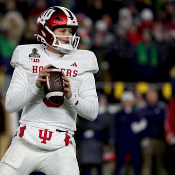 Dec 20, 2024; Notre Dame, Indiana, USA; Indiana Hoosiers quarterback Kurtis Rourke (9) drops to throw during the first quarter against the Notre Dame Fighting Irish at Notre Dame Stadium. Mandatory Credit: Trevor Ruszkowski-Imagn Images