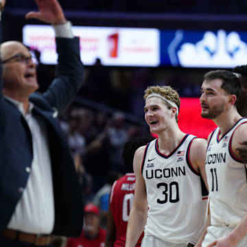 Nov 6, 2024; Storrs, Connecticut, USA; Connecticut Huskies forward Liam McNeeley (30), forward Alex Karaban (11) and Connecticut Huskies head coach Dan Hurley react after a play against the Sacred Heart Pioneers in the second half at Harry A. Gampel Pavilion. Mandatory Credit: David Butler II-Imagn Images