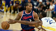 Apr 13, 2025; San Francisco, California, USA; Golden State Warriors forward Draymond Green (23) extends for the ball against LA Clippers forward Kawhi Leonard (2) during the third quarter at Chase Center. Mandatory Credit: Robert Edwards-Imagn Images