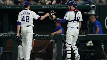 May 15, 2025; Arlington, Texas, USA; Texas Rangers pitcher Jacob deGrom (48) fist bumps catcher Jonah Heim (28) after pitching the seventh inning against the Houston Astros at Globe Life Field. Mandatory Credit: Raymond Carlin III-Imagn Images