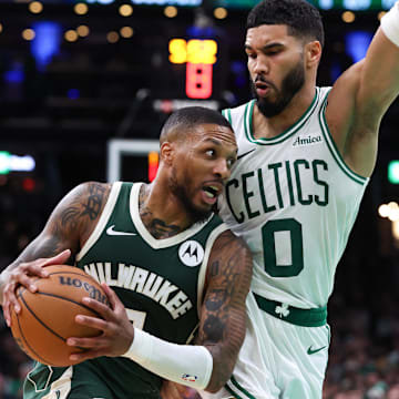 Oct 28, 2024; Boston, Massachusetts, USA; Milwaukee Bucks guard Damian Lillard (0) drives to the basket defended by Boston Celtics forward Jayson Tatum (0) during the first half at TD Garden. Mandatory Credit: Paul Rutherford-Imagn Images