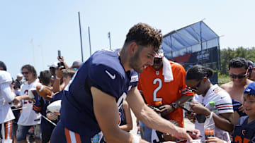 Cole Kmet signs autographs for fans at Halas Hall during the 2024 training camp.