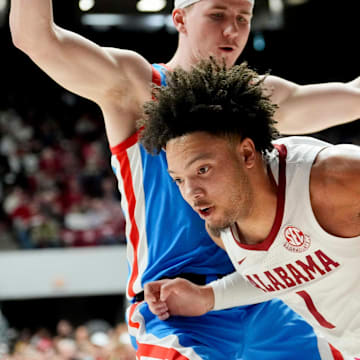 Jan 14, 2025; Tuscaloosa, AL, USA; Alabama guard Mark Sears (1) drives along the baseline with Ole Miss guard Sean Pedulla (3) defending at Coleman Coliseum. Mandatory Credit: Gary Cosby Jr.-Tuscaloosa News