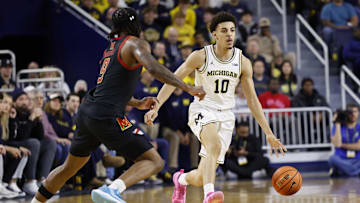 Mar 5, 2025; Ann Arbor, Michigan, USA;  Michigan Wolverines guard Justin Pippen (10) dribbles defended by Maryland Terrapins guard Selton Miguel (9) in the first half at Crisler Center. Mandatory Credit: Rick Osentoski-Imagn Images