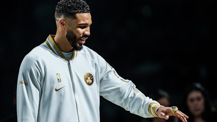 Oct 22, 2024; Boston, Massachusetts, USA; Boston Celtics forward Jayson Tatum (0) reacts after receiving his championship ring during the opening night banner raising ceremony before the start of the game against the New York Knicks at TD Garden. Mandatory Credit: David Butler II-Imagn Images Oct 22, 2024; Boston, Massachusetts, USA; Boston Celtics forward Jayson Tatum (0) reacts after receiving his championship ring during the opening night banner raising ceremony before the start of the game against the New York Knicks at TD Garden. Mandatory Credit: David Butler II-Imagn Images