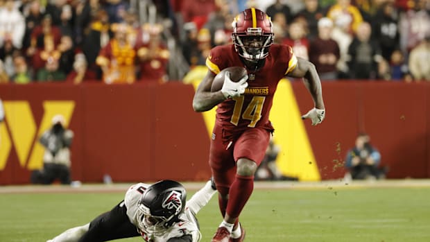 Washington Commanders wide receiver Olamide Zaccheaus (14) runs with the ball