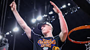 Alex Condon helps cut down the net after the Florida Gators' win over Houston in the national championship.
