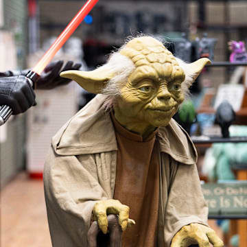 A life-size figure of Yoda from Star Wars is seen in the storefront at Whimsy Cellar in West Des Moines.