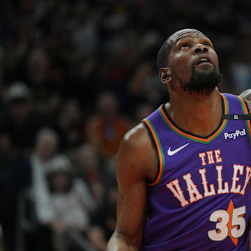 Mar 30, 2025; Phoenix, Arizona, USA; Phoenix Suns forward Kevin Durant (35) and Houston Rockets forward Jabari Smith Jr. (10) fight for position in the first half at Footprint Center. Mandatory Credit: Rick Scuteri-Imagn Images