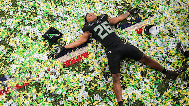 Oregon Ducks linebacker Devon Jackson (26) makes a confetti angel on Sunday, Dec. 8, 2024, after the Big Ten Championship gam