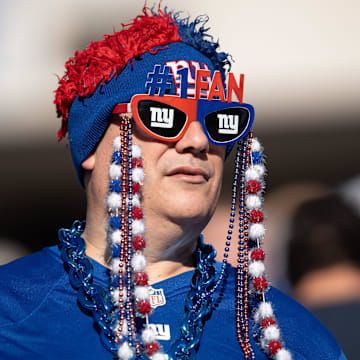 New York Giants fan cheers on his team during a game between the New York Giants and the Washington Commanders.