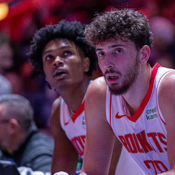 Alperen Sengun and Amen Thompson watch a game against the Pistons in Jan. 2024.