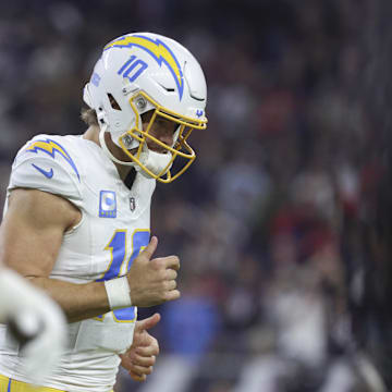 Los Angeles Chargers quarterback Justin Herbert jogs off the field after a play during the game against the Houston Texans in an AFC wild card game at NRG Stadium. 