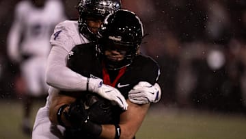 TCU Horned Frogs linebacker Namdi Obiazor (4) tackles Cincinnati Bearcats tight end Joe Royer (11) in the third quarter of the NCAA football game between Cincinnati Bearcats and TCU Horned Frogs at Nippert Stadium in Cincinnati on Saturday, Nov. 30, 2024.